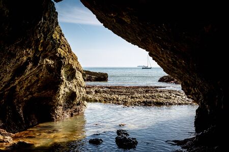 Looking out to sea from a cave at Freshwater Bay on the Isle of Wightの写真素材