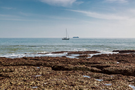 Looking out over the ocean with rocks visible at low tide, at Freshwater Bay on the Isle of Wight
