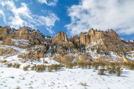 Looking up at a rugged rocks in Utah, on a sunny winters day with snow on the ground