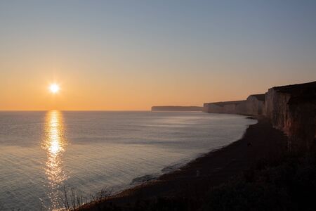 The Seven Sisters cliffs silhouetted at sunsetの写真素材