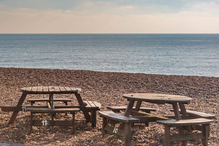 Empty tables and chairs at the beach, on a sunny day out of season