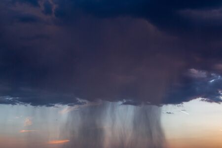 Dramatic storm clouds at sunsetの写真素材