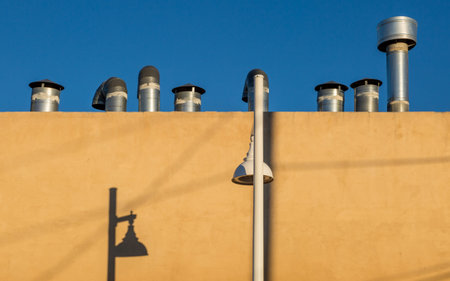 Pipes on a roof and shadows on a wall