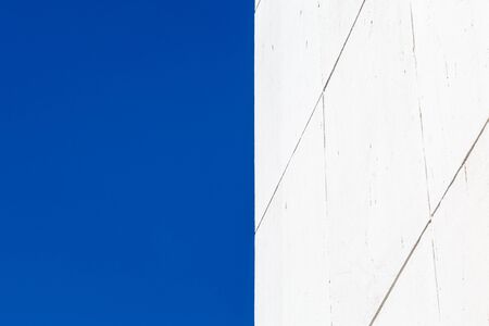 A bright white building against a clear blue skyの写真素材
