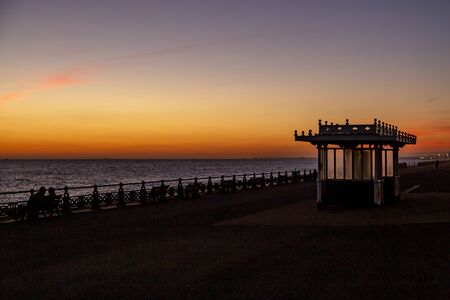 Sunset at Brighton, viewed from the promenade, with a silhouetted foregroundの写真素材