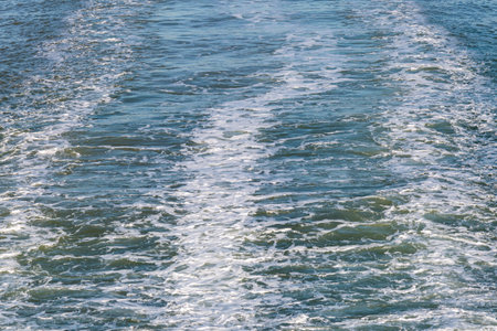 A full frame photograph of wake water following a ferry