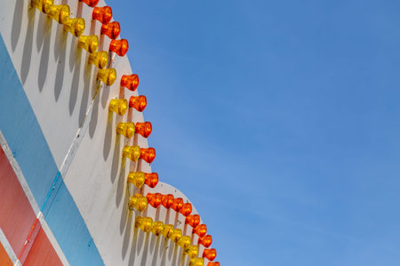 Looking up at part of a fairground ride against a blue skyの写真素材