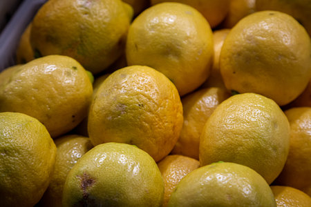 A display of lemons for sale on a market stall
