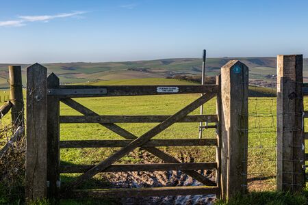 A wooden gate along the South Downs Way, on Firle Beacon in Sussexの写真素材