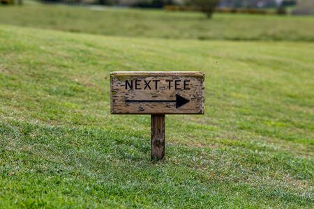 A small directional sign on a golf courseの写真素材
