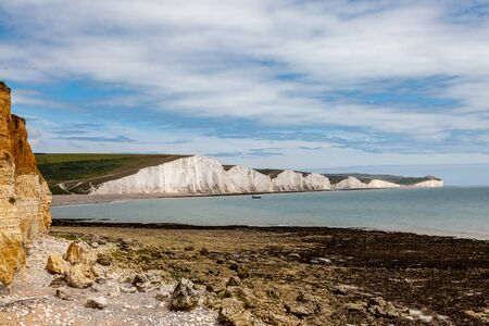 A view of the Seven Sisters Cliffs on the Sussex coast, from the rocky beach at Hope Gapの写真素材