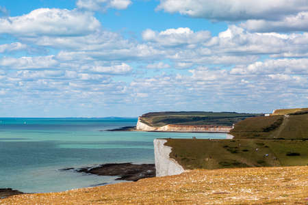 A view of the Seven Sisters Cliffs and the sea from along the South Downs Way, on a sunny summers dayの写真素材