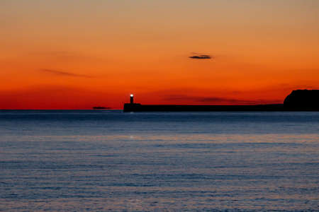 Newhaven Lighthouse in Sussex, at Sunsetの写真素材