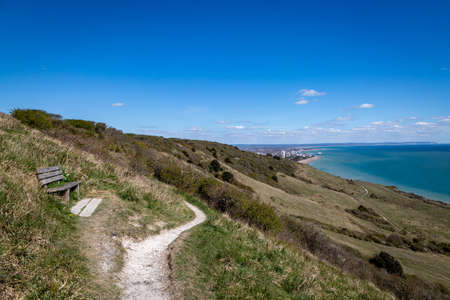 Looking along a coastal pathway on the Sussex coast with the town of Eastbourne in the distanceの写真素材