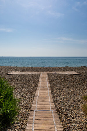 A wooden boardwalk on the pebbles, at Newgale Beach on the Pembrokeshire Coast