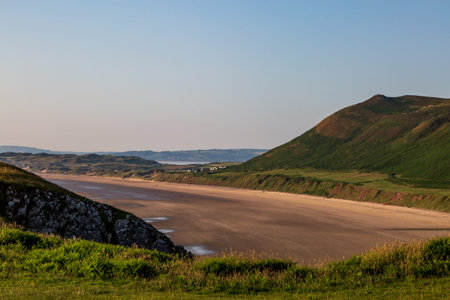 Looking out over the vast sandy beach at Rhossili Bay along the Gower Peninsula