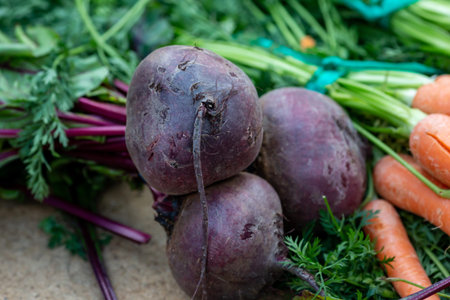 Beetroots and carrots for sale on a farmers market stall