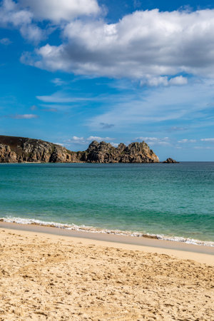 Rock formations and the sandy beach, at Porthcurno on the south coast of Cornwallの写真素材
