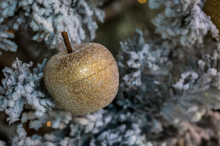 A close up of a Christmas decoration on a tree, with a shallow depth of field