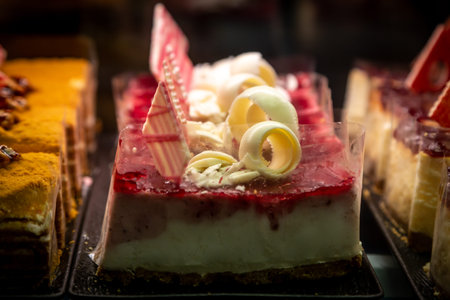 A display of pretty cream cakes in a confectioners windowの写真素材