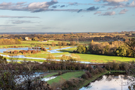 Looking out towards Hamsey church from near Lewes, with the fields flooded following recent heavy rainfallの写真素材