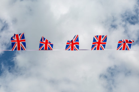 Looking up at Union Jack bunting against the skyの写真素材