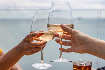 A celebratory toast at the coast, with a shallow depth of field