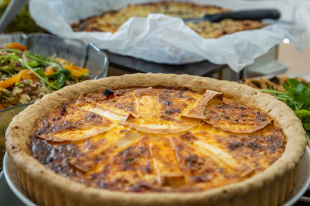 A close up of a  savoury pie ready to eat on a buffet tableの写真素材