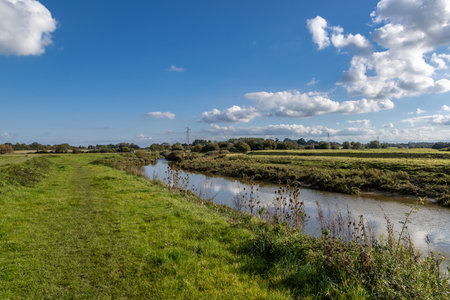A grass pathway running alongside the River Ouse, near Lewes in Sussexの写真素材