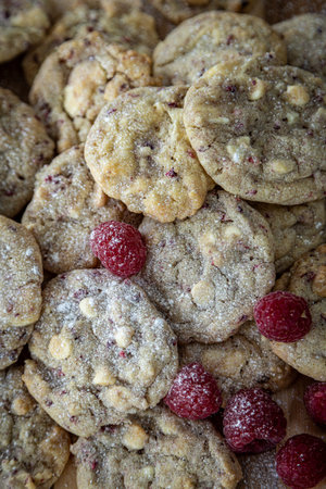 Looking down at freshly baked biscuits, with raspberries for decorationの写真素材