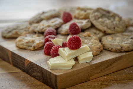 Freshly baked biscuits arranged on a wooden board, with focus on foregroundの写真素材