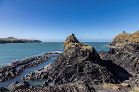 The rugged coastline at Abereiddi on the Pembrokeshire coast, with a blue sky overheadの写真素材