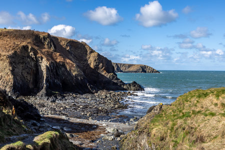 A secluded beach near Trefin on the Pembrokeshire coast, with a blue sky overheadの写真素材