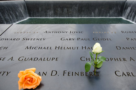 2013  Two roses are left beside the name of  Alan D. Feinberg, a fire fighter of the New York Fire...