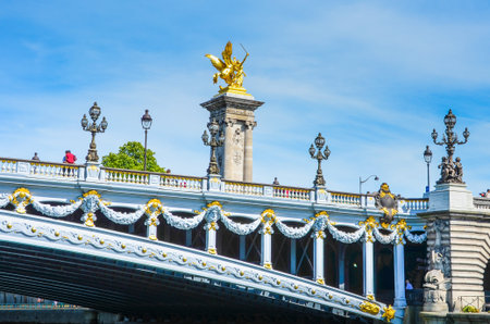 Paris, France , May 29, 2011 - Pont Alexandre III spans the Seine River in Paris  The ornate bridge, with its exuberant Art Nouveau lamps, cherubs, nymphs and winged horses at either end, was completed in 1900 for the Universal Exhibition held in Paris のeditorial素材