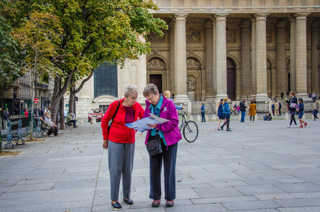 Paris, France, October 12, 2014: Two senior women check their map at Place St. Sulpice.のeditorial素材