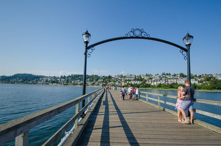 White Rock, Canada, August 25, 2014 - Couple pauses for a romantic moment while walking on the historic promenade on the Pacific coast of this tourist town in British Columbia.のeditorial素材