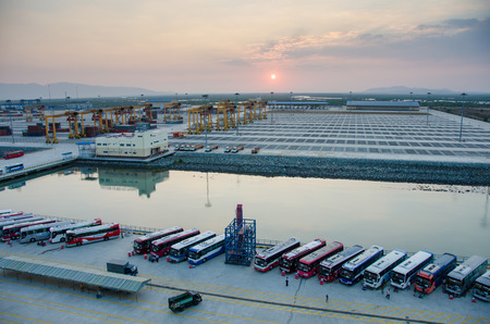 Phu My, Vietnam, February 7, 2015 - Tourist buses are lined at sunrise at the cruise port waiting to take tour groups  to Ho Chi Minh City and other sites.のeditorial素材