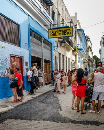 HAVANA â CUBA, JUNE 20, 2016: A couple autograph the wall outside of one of Hemingwayâs favorite bars, the legendary La Bodeguita del Medio on the Emperado in the La Habana Vieja neighborhood.のeditorial素材