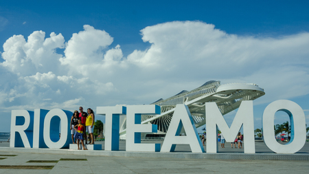 Rio de Janeiro, Brazil, February 26, 2017 â Family poses in front of a Rio Teamo sculpture in front of the Museum of Tomorrow on the waterfront of the cityâs port historical port district.のeditorial素材