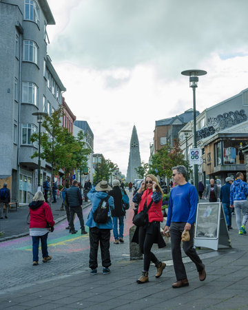 Reykjavik, Iceland, August 28, 2018 - Tourists walk along the main avenue in the city crowded with shops and restaurants down the hill from the Hallgrimskirja Church in the distance.のeditorial素材