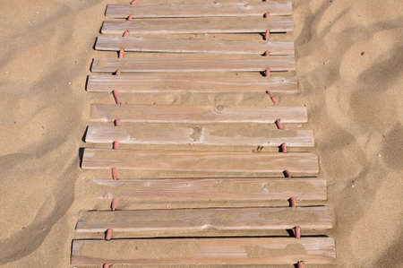 wooden bridge in the sandの写真素材