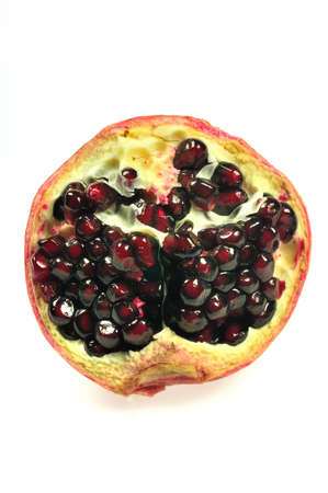 half of a pomgranate isolated on white backgroundの写真素材