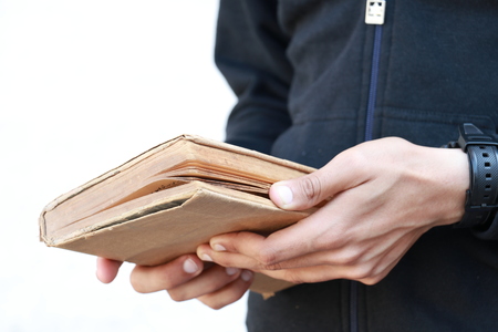 Boy Holding old Book in Handsの写真素材