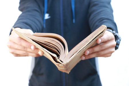 Boy Holding old Book in Hands