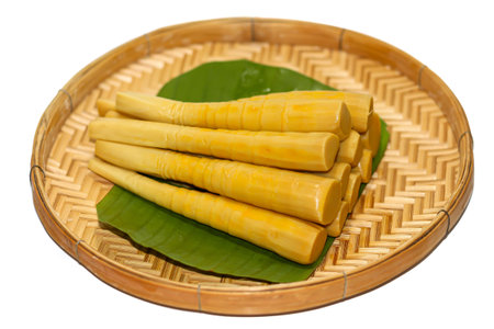 Bamboo shoots in bamboo basket isolated on white backgroundの写真素材