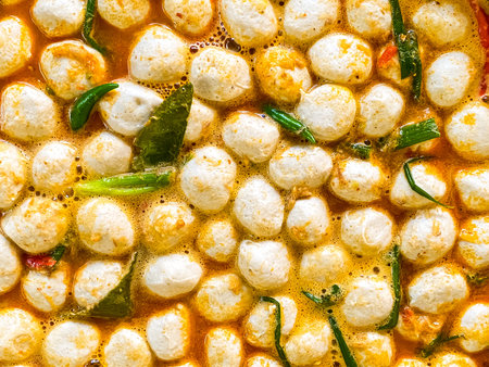 Close up of white fish ball in hot oil. Thai food.