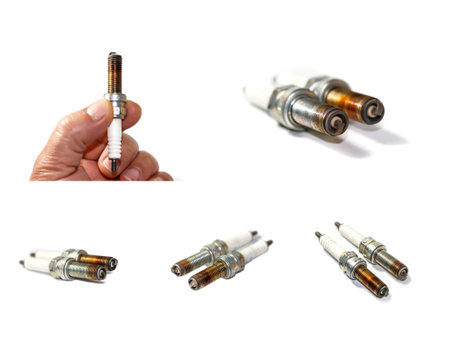 Spark plugs in hand on a white background. Isolated.
