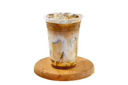 Ice coffee in plastic cup on wooden plate isolated on white background.の写真素材