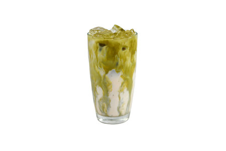 Iced matcha latte with ice in glass on white backgroundの写真素材